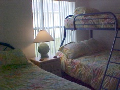 Bunk bed with double bed at the bottom and a single bed on the top